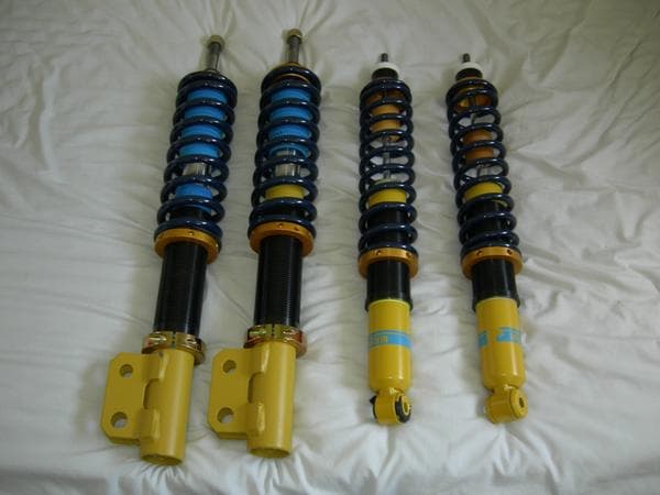 Automotive suspension damper coilovers and steering linkage